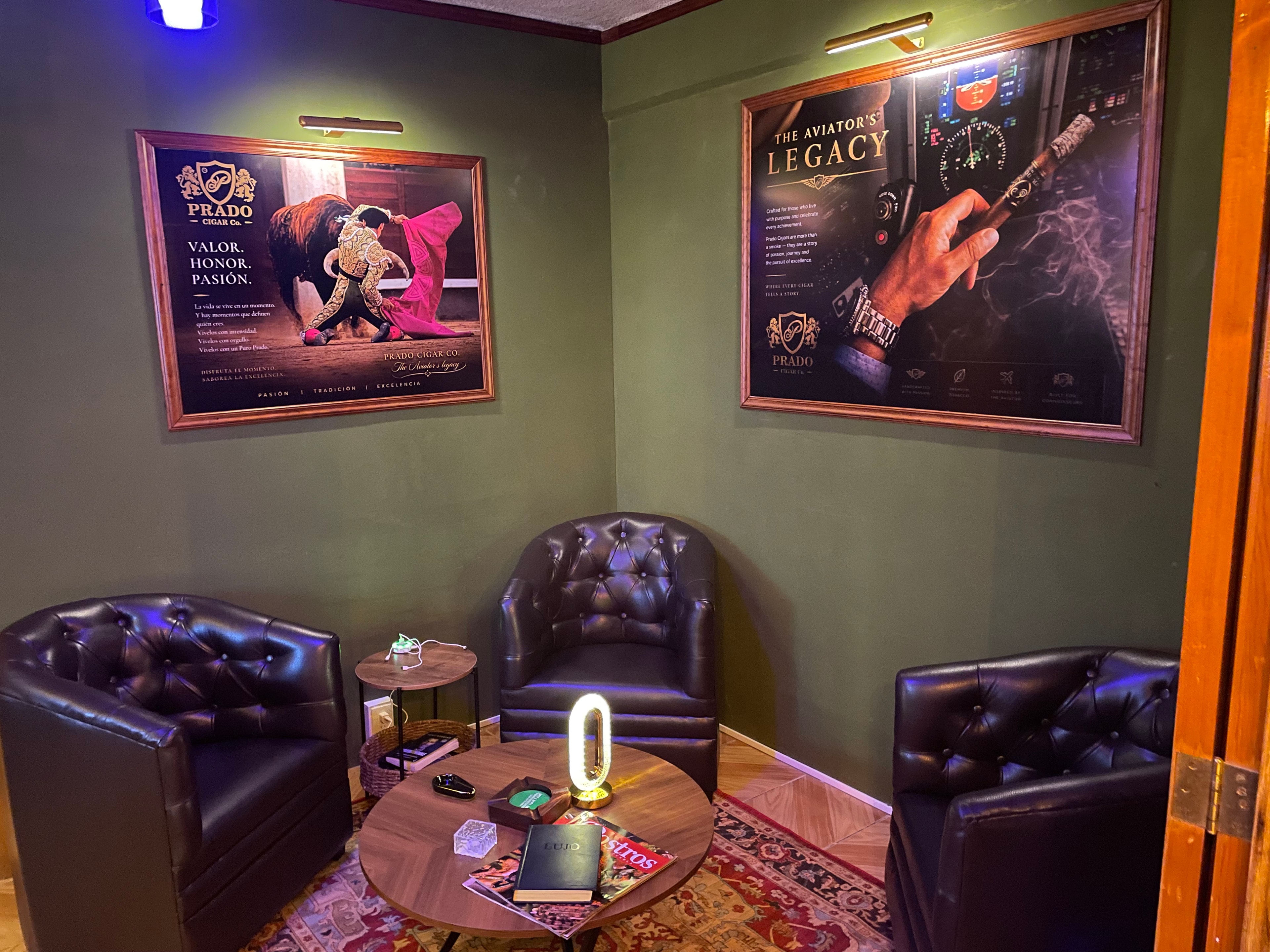 Prado Cigar private lounge — three leather armchairs and artwork